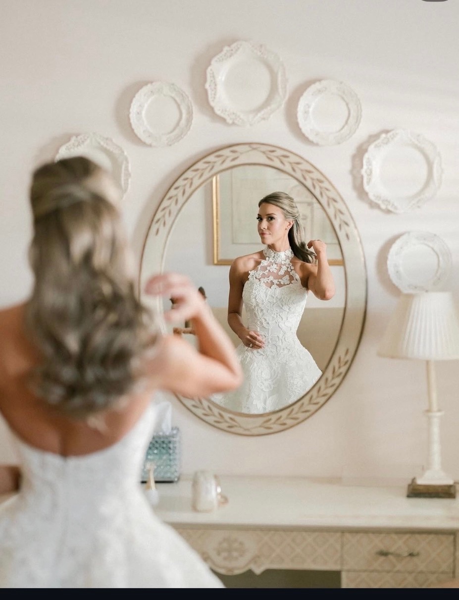 Bride preparing in front of a mirror